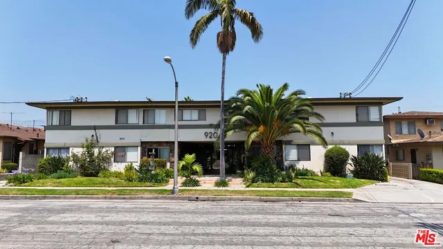 a front view of a house with a garden and plants