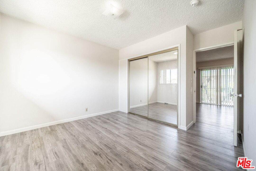 920 North 1st Street Alhambra, CA 91801 - Photo 7 of 22 an empty room with wooden floor & windows