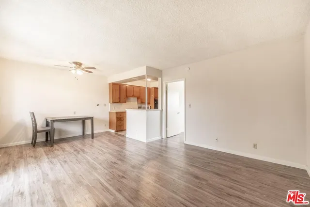 a view of a kitchen with a sink and a refrigerator
