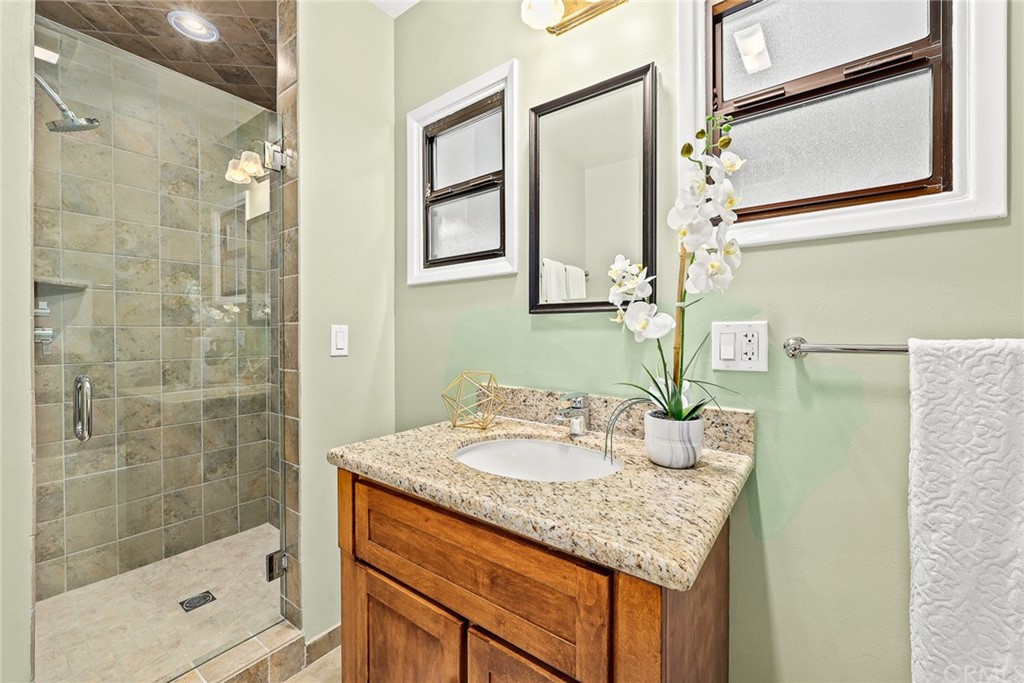 1183 Menlo Drive Altadena, CA 91001 - Photo 20 of 34 a bathroom with a granite countertop sink and a mirror