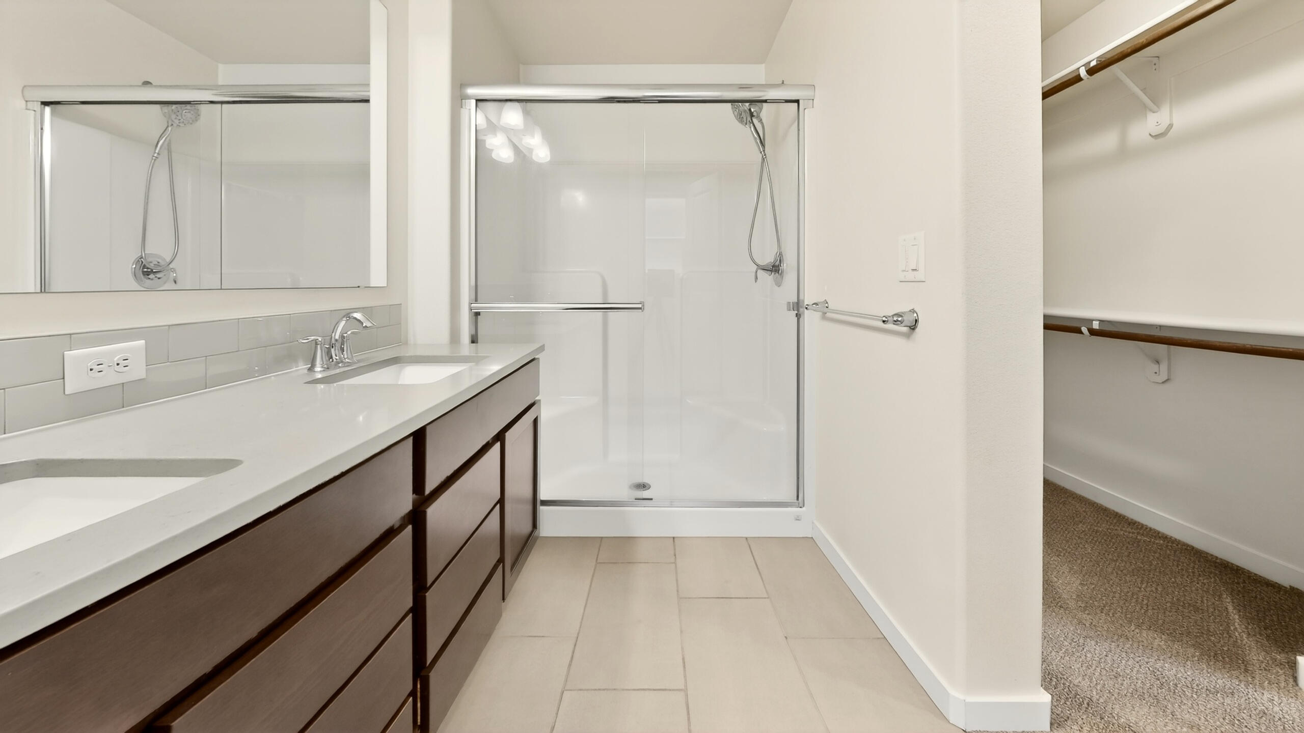 680 McKinney Ranch Road Sisters, OR 97759 - Photo 32 of 41 a bathroom with a double vanity sink a mirror and a shower