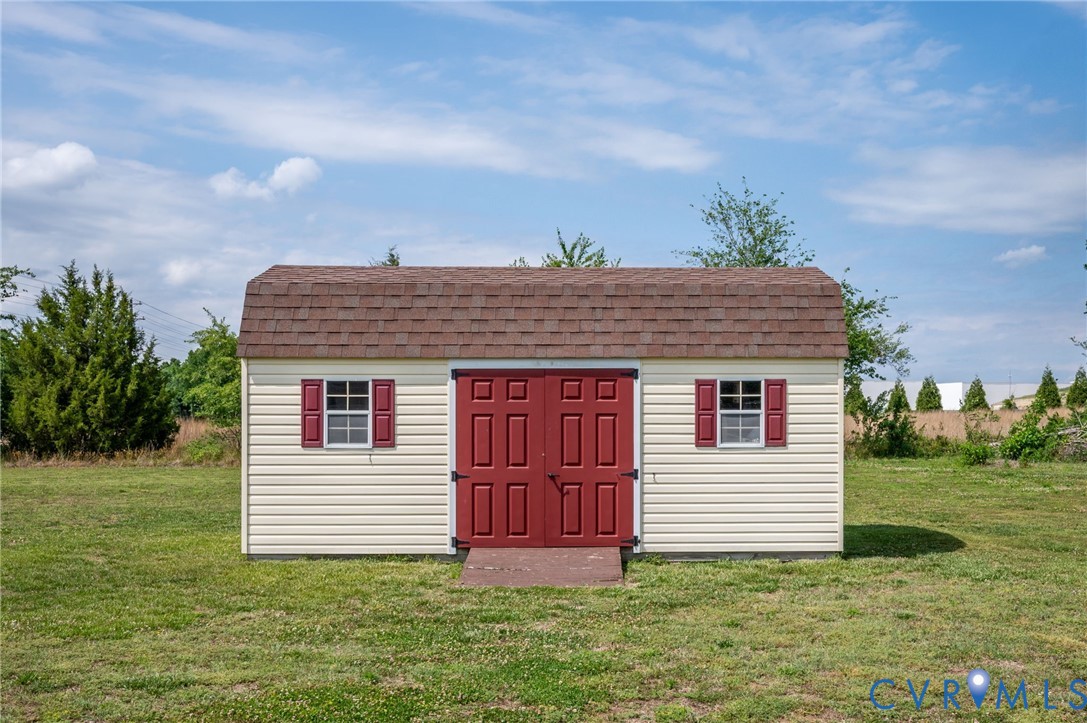 5280 West Quaker Road Disputanta, VA 23875 - Photo 18 of 33 a view of a house with a yard
