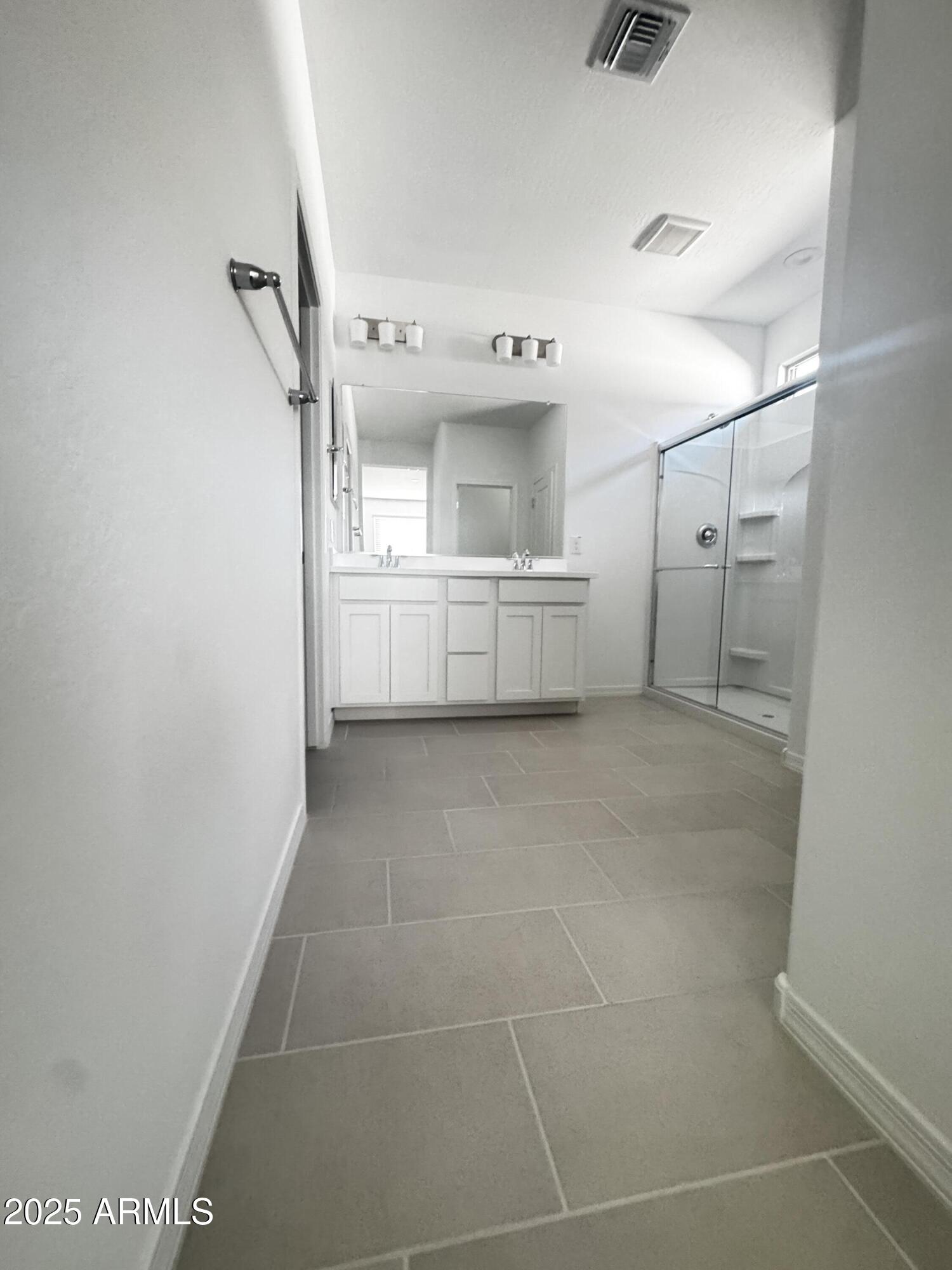 9957 West Mitchell Avenue Avondale, AZ 85392 - Photo 14 of 19 a bathroom with a sink toilet and shower