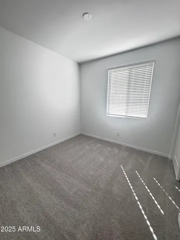 a bathroom with a toilet and a mirror