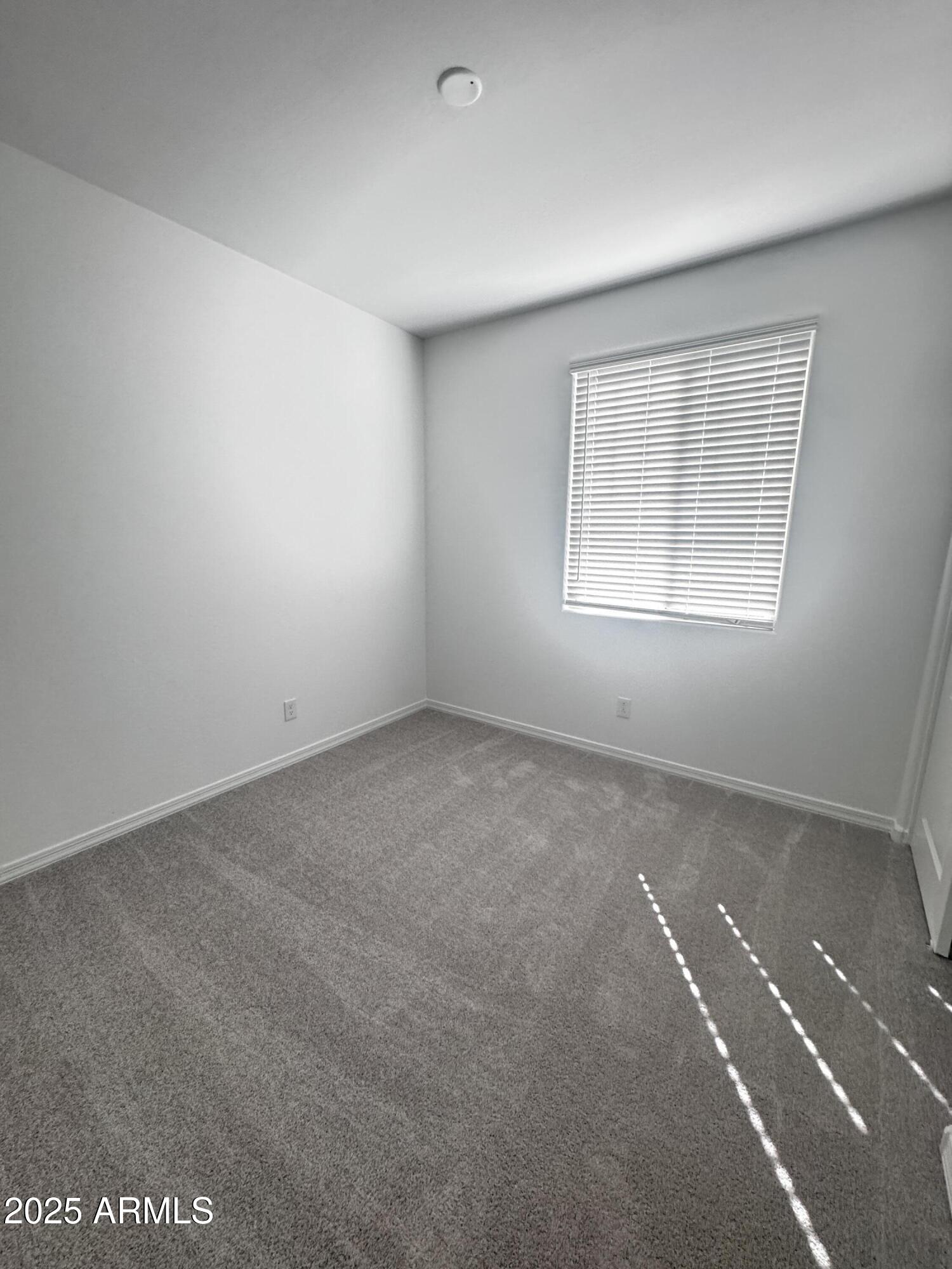 9957 West Mitchell Avenue Avondale, AZ 85392 - Photo 16 of 19 an empty room with a window