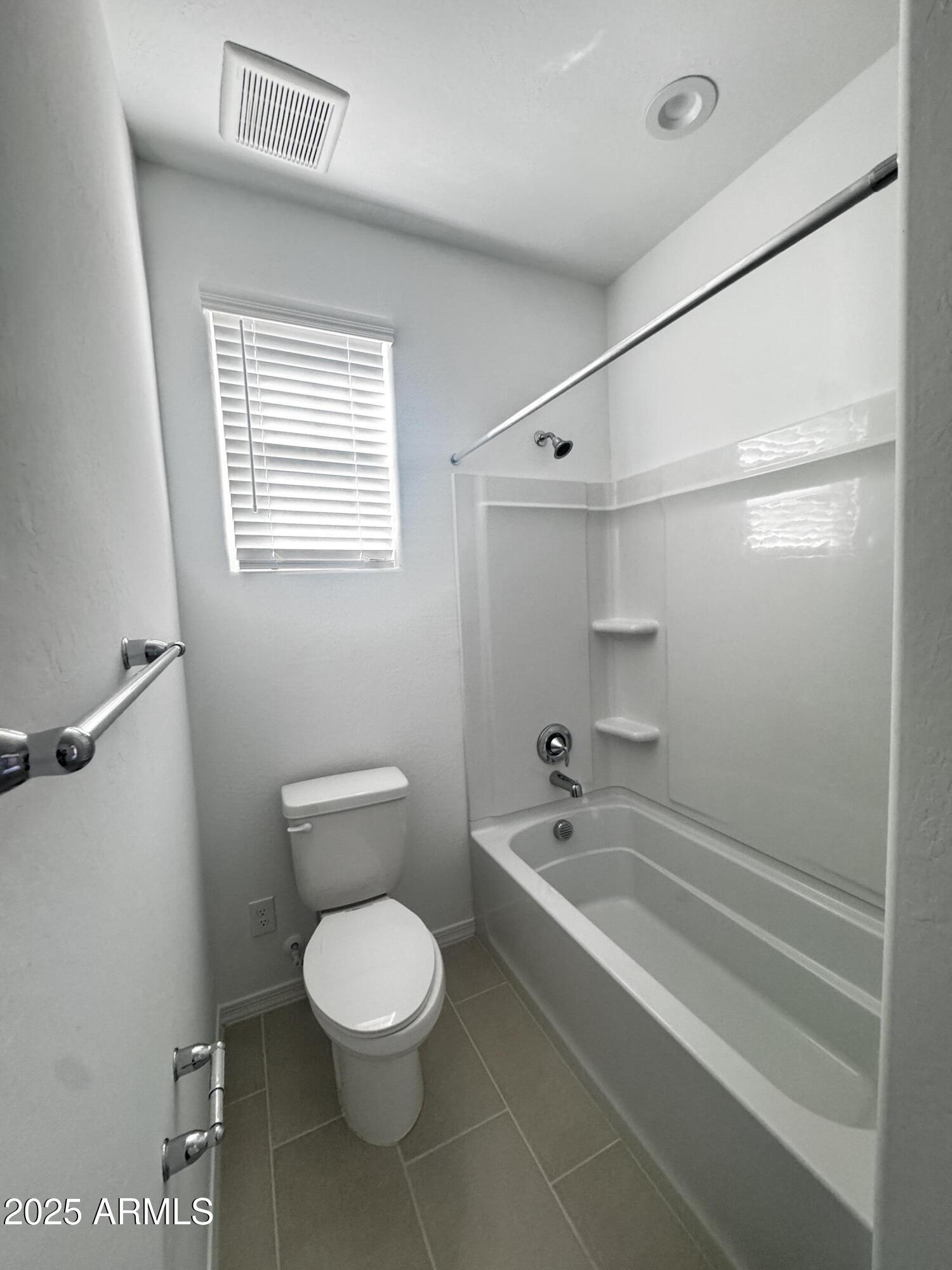 9957 West Mitchell Avenue Avondale, AZ 85392 - Photo 18 of 19 a bathroom with a toilet a sink and a bathtub