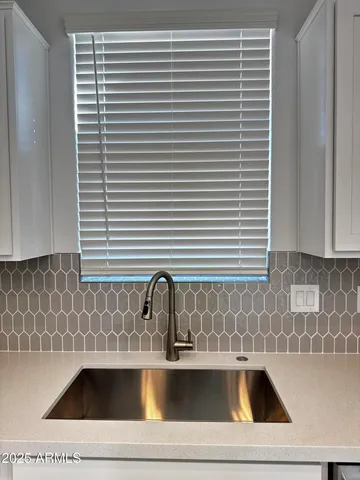 a kitchen with stainless steel appliances kitchen island granite countertop a refrigerator a sink a stove with cabinets