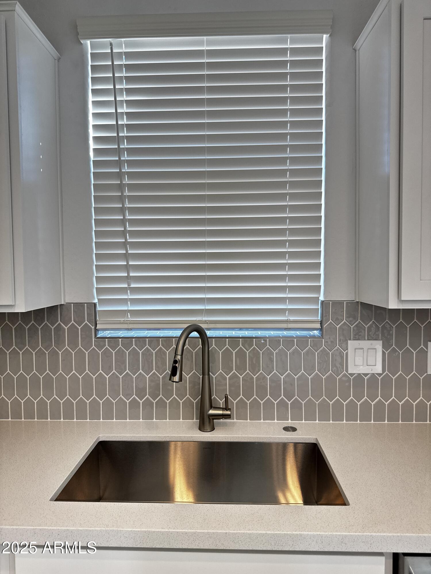 9957 West Mitchell Avenue Avondale, AZ 85392 - Photo 7 of 19 a kitchen with a sink and a window