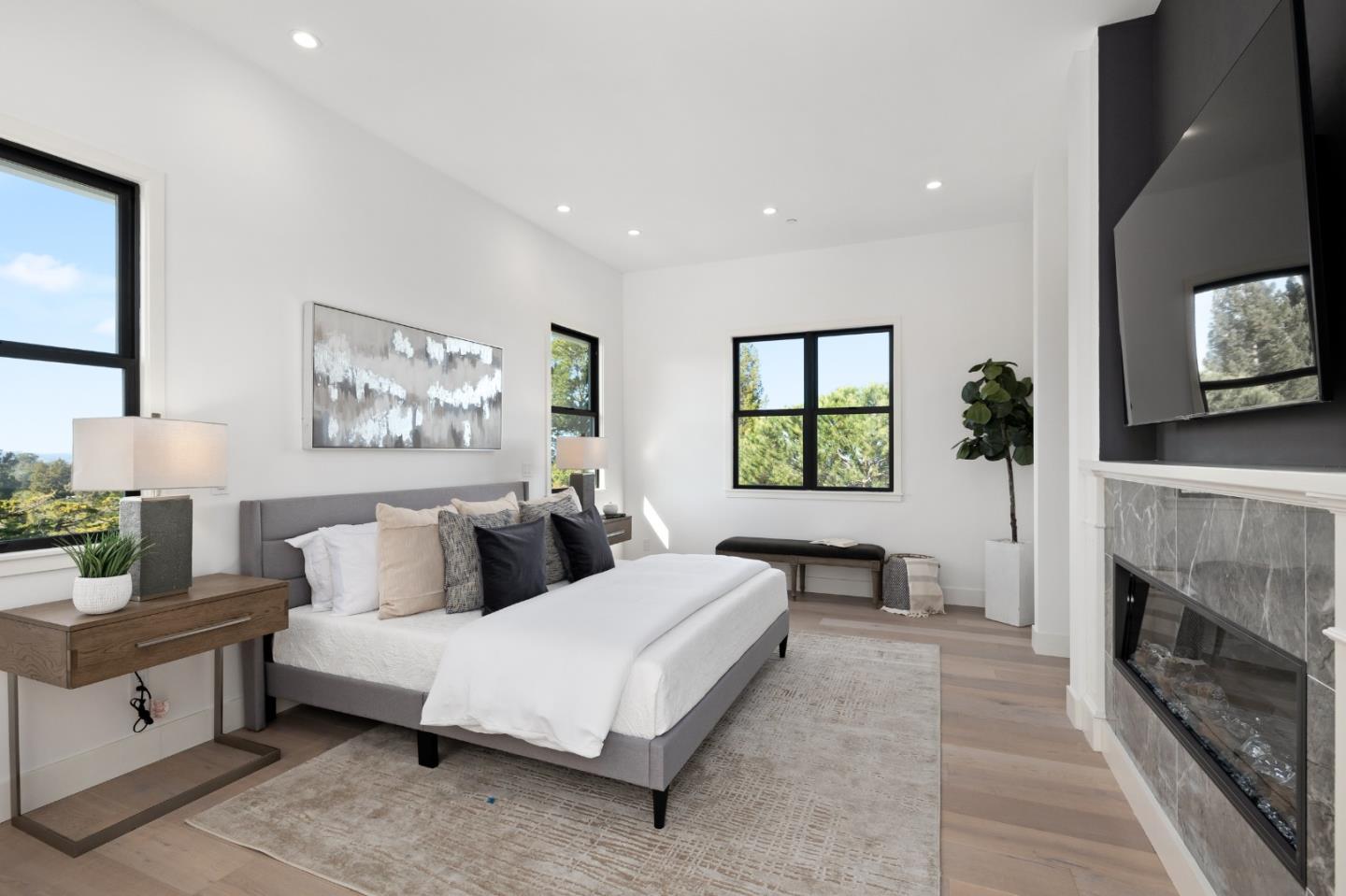 245 Eucalyptus Avenue Hillsborough, CA 94010 - Photo 13 of 27 a bedroom with a bed and a fireplace