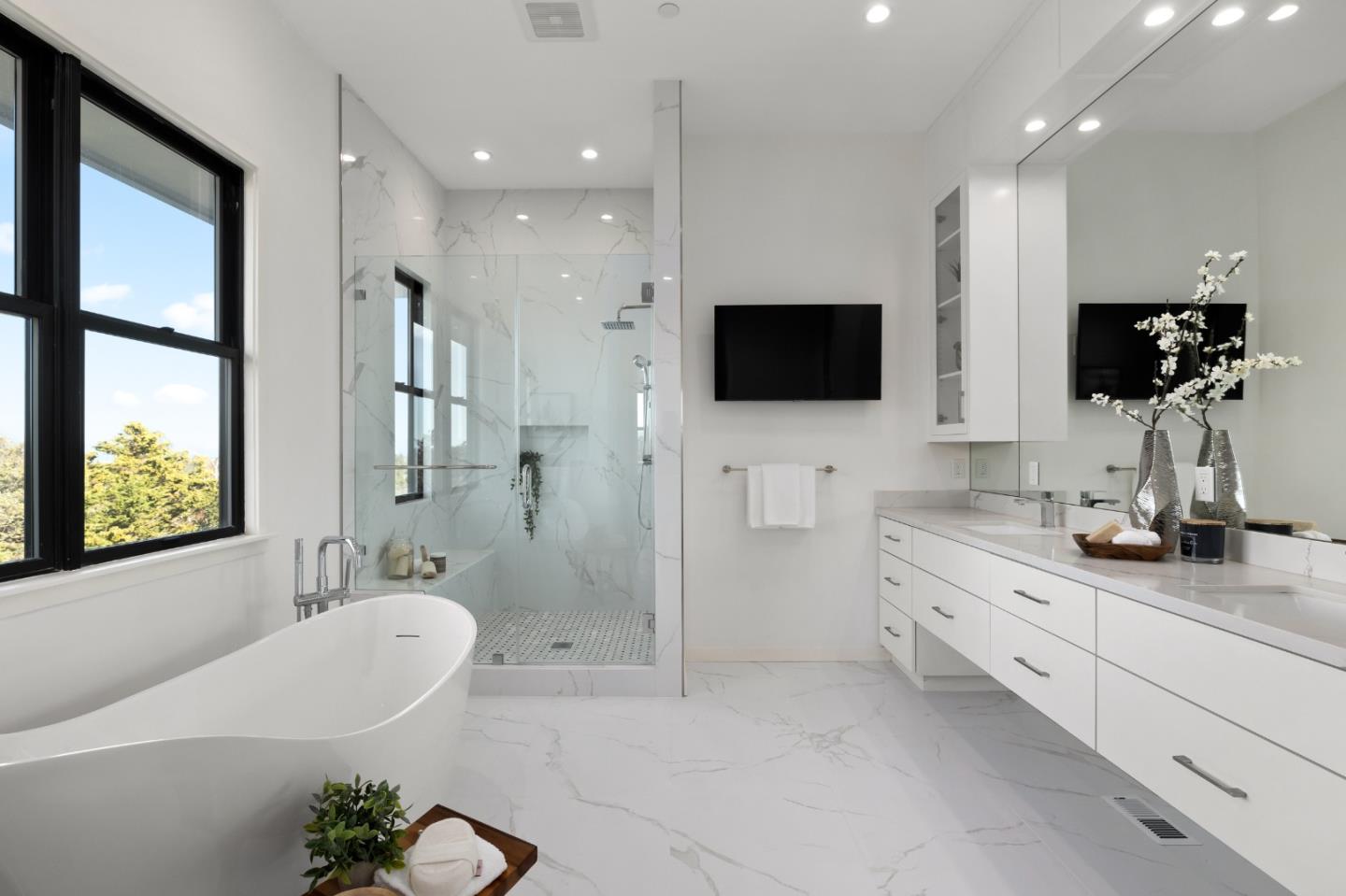 245 Eucalyptus Avenue Hillsborough, CA 94010 - Photo 14 of 27 a bathroom with a double sink a large mirror and a bathtub