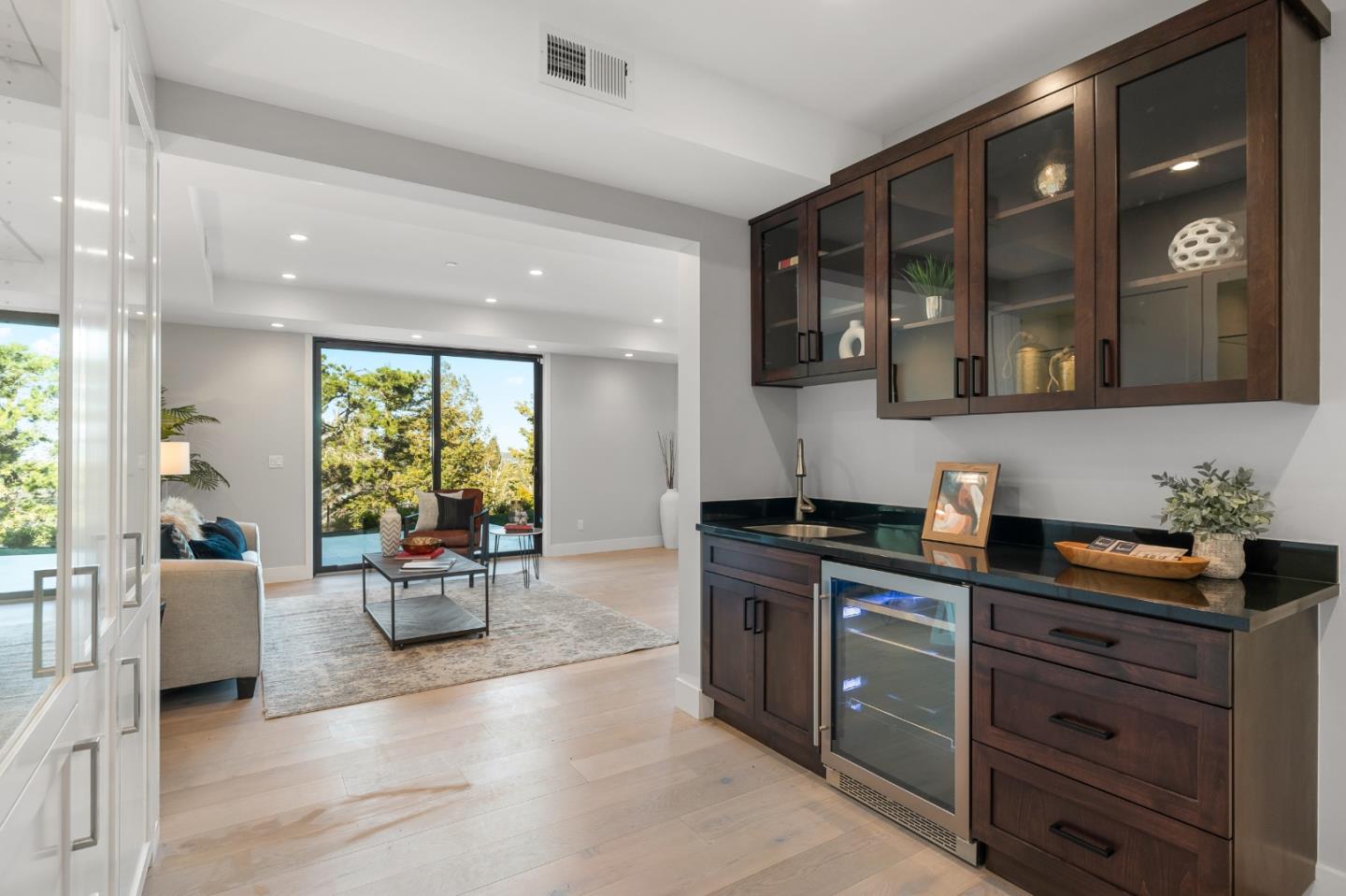 245 Eucalyptus Avenue Hillsborough, CA 94010 - Photo 15 of 27 a kitchen with stainless steel appliances kitchen island granite countertop a sink and cabinets