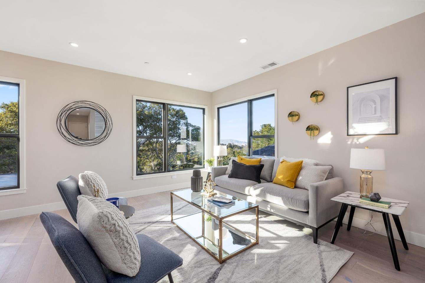 245 Eucalyptus Avenue Hillsborough, CA 94010 - Photo 23 of 27 a living room with furniture and a large window