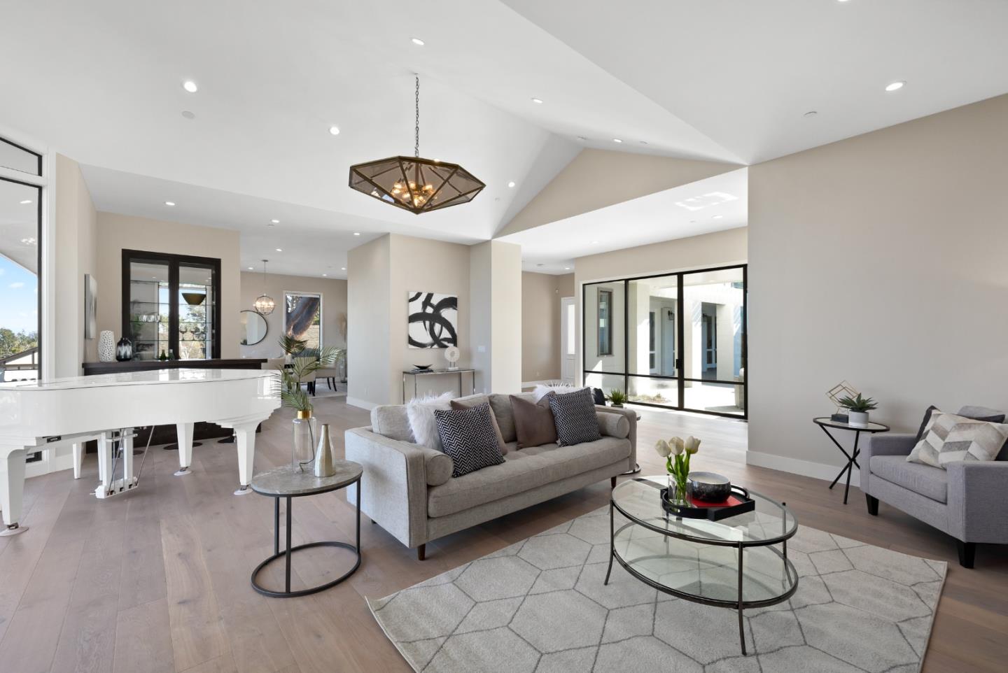 245 Eucalyptus Avenue Hillsborough, CA 94010 - Photo 4 of 27 a living room with furniture kitchen view and a wooden floor