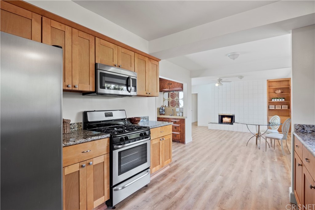 3653 El Caminito La Crescenta, CA 91214 - Photo 11 of 75 a kitchen with granite countertop wooden floors wooden cabinets and stainless steel appliances