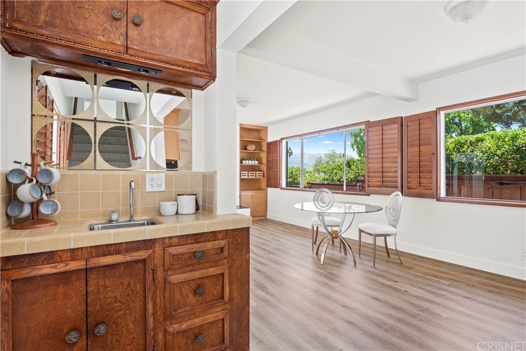 3653 El Caminito La Crescenta, CA 91214 - Photo 20 of 75 a kitchen with a table chairs and wooden floor