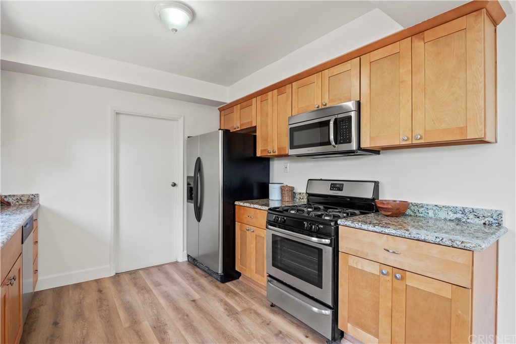 3653 El Caminito La Crescenta, CA 91214 - Photo 7 of 75 a kitchen with granite countertop wooden cabinets stainless steel appliances and a counter space