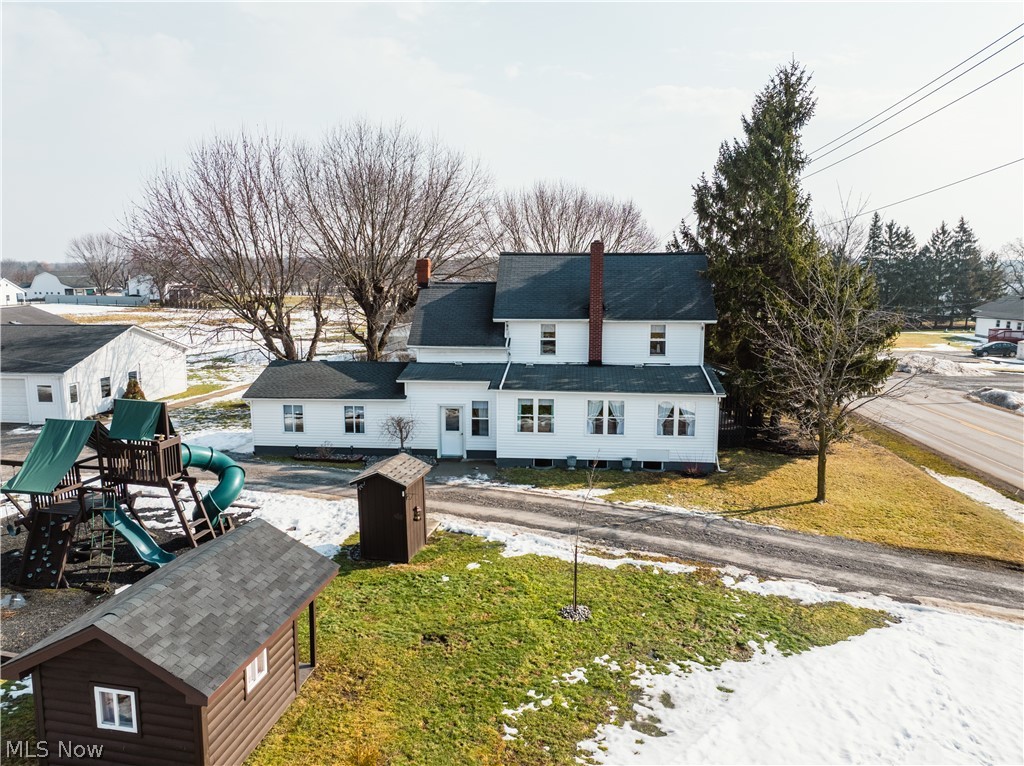 16350 Nauvoo Road Middlefield, OH 44062 - Photo 2 of 50 Rear view of property with a playground, an outbuilding, a chimney, and a yard