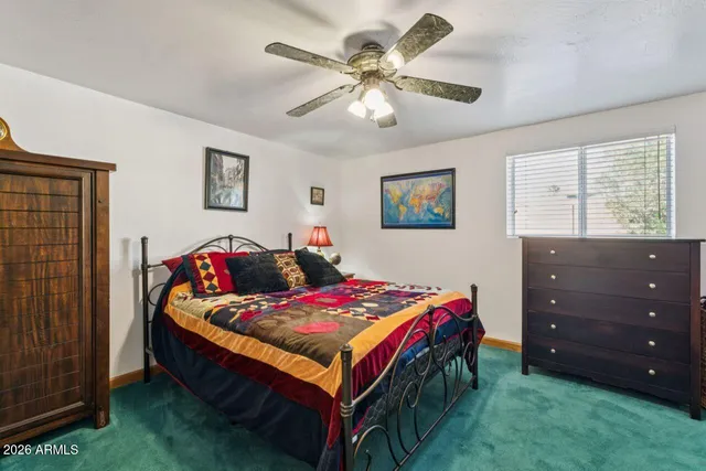 a view of a hallway with wooden floor and a bathroom