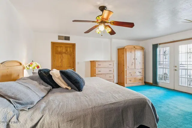 a view of a house with backyard and a tree
