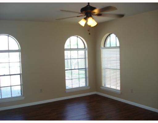 335 Bay View Boulevard Portland, TX 78374 - Photo 4 of 4 an empty room with windows and chandelier fan