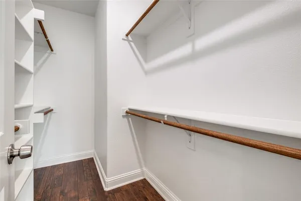 a view of closet with wooden floor