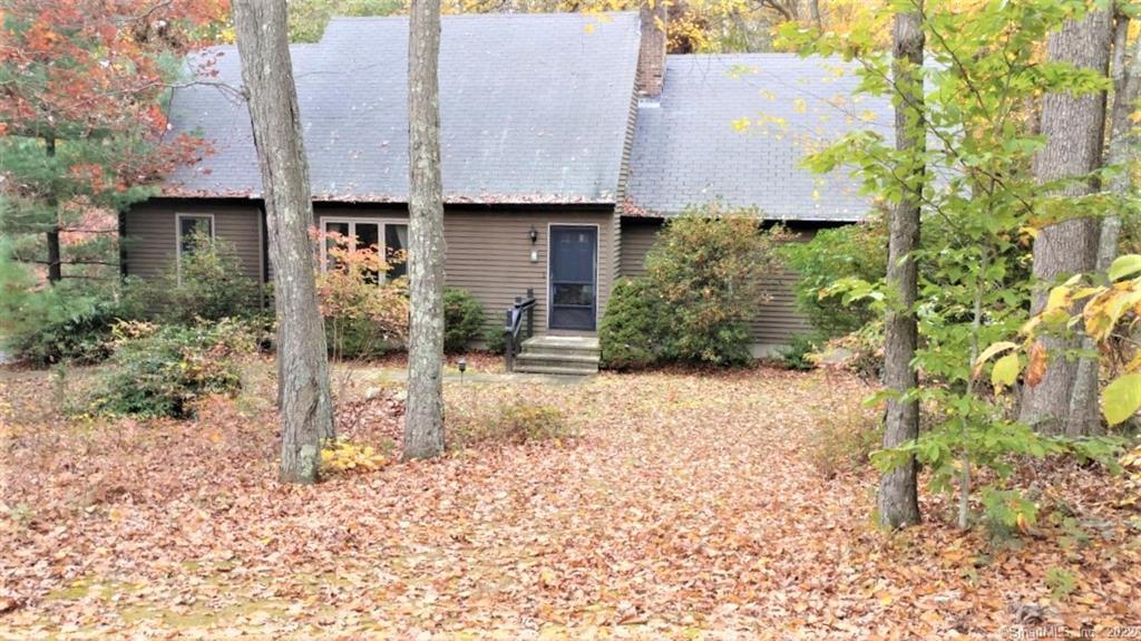 Lightly treed front yard is secluded from street.