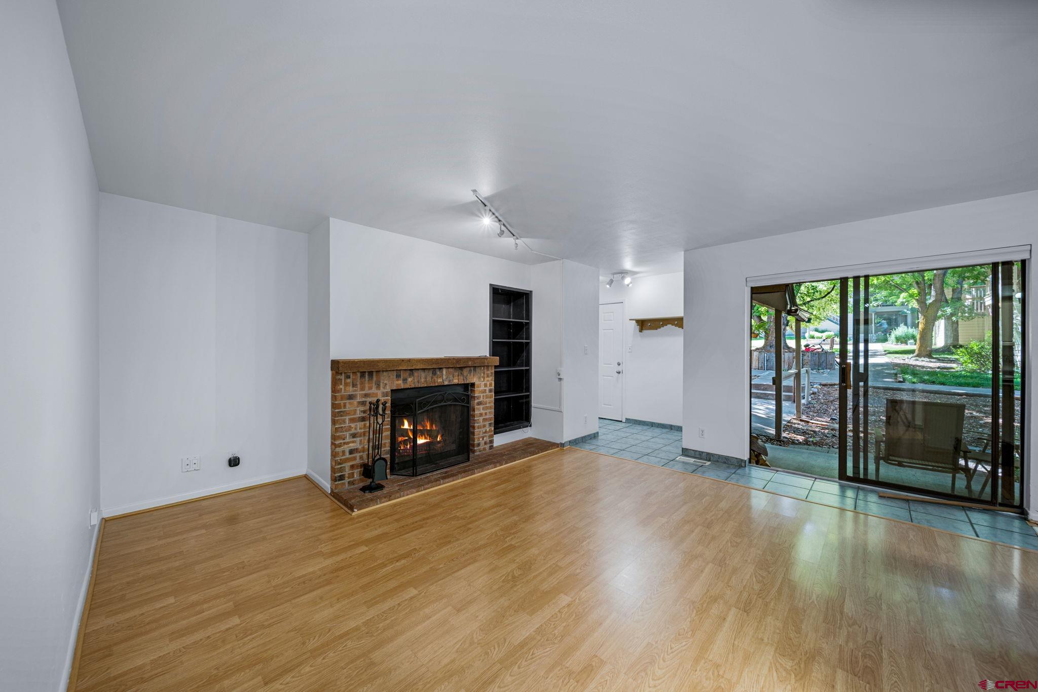 1200 Florida Road, Unit 11 Durango, CO 81301 - Photo 19 of 19 an empty room with wooden floor fireplace and windows