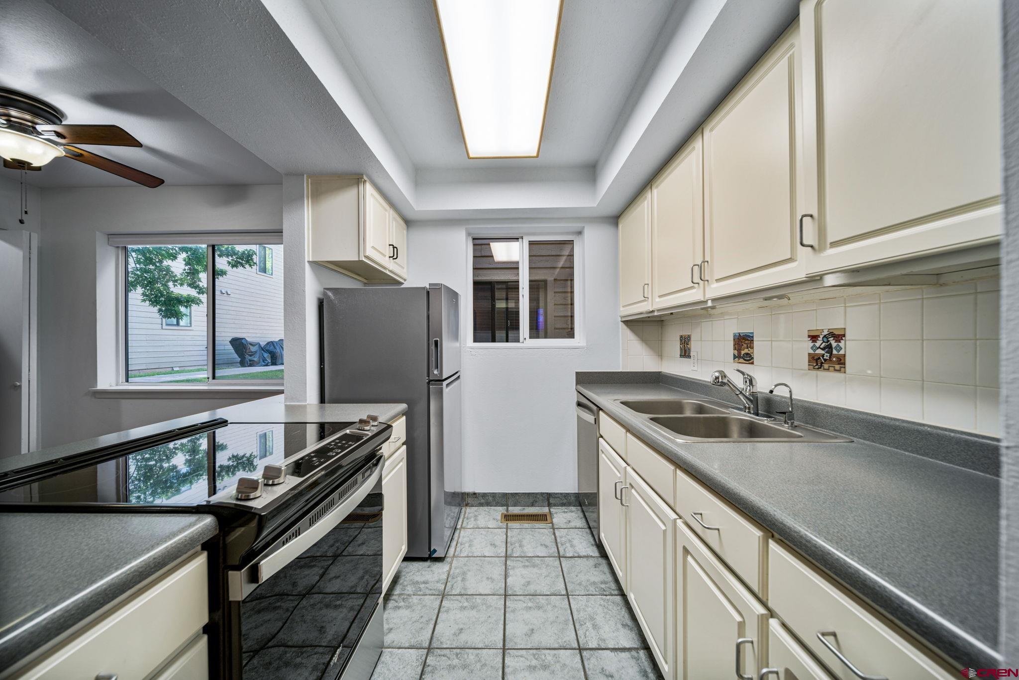 1200 Florida Road, Unit 11 Durango, CO 81301 - Photo 7 of 19 a kitchen with a sink appliances and cabinets