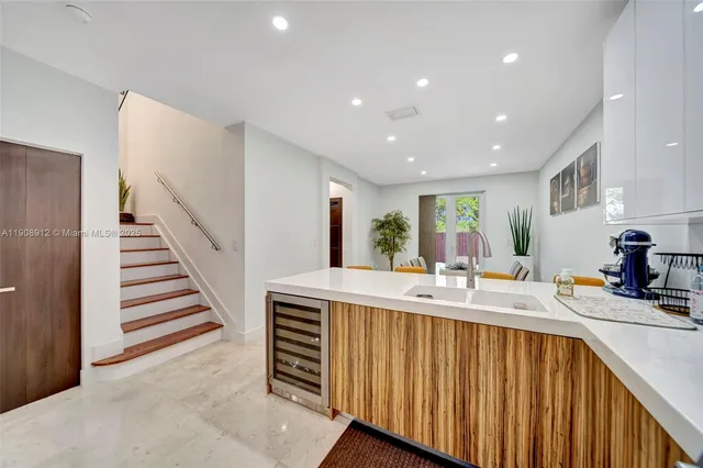 a kitchen with stainless steel appliances granite countertop a stove a refrigerator and a window