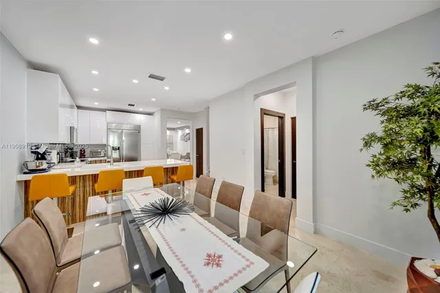 a backyard of a house with chairs and a tree