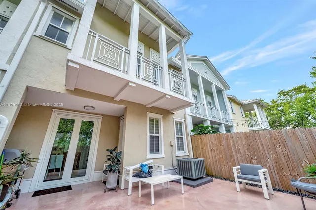 a bedroom with a bed and a flat tv screen on a dresser