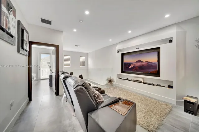 a bed room with a bed and a television