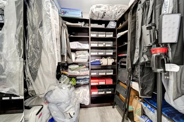 a view of a backyard with wooden fence and potted plants