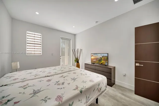 a view of a yard with plants and wooden fence