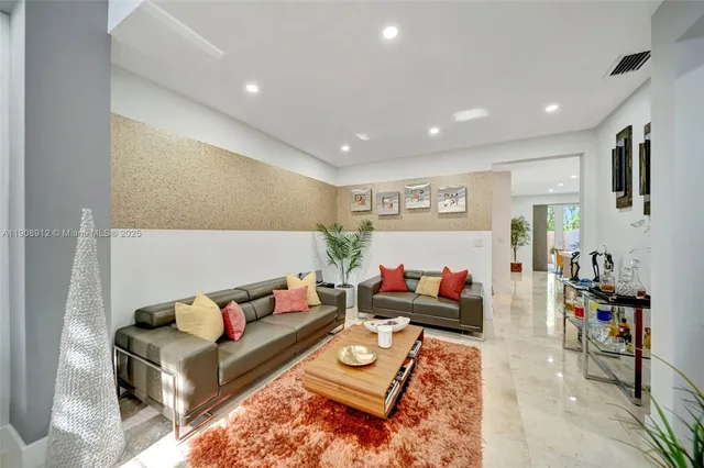 a open kitchen with stainless steel appliances granite countertop a stove top oven a sink dishwasher and white cabinets with wooden floor