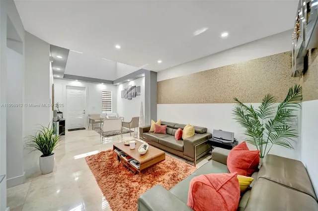 a kitchen with stainless steel appliances a refrigerator sink and microwave