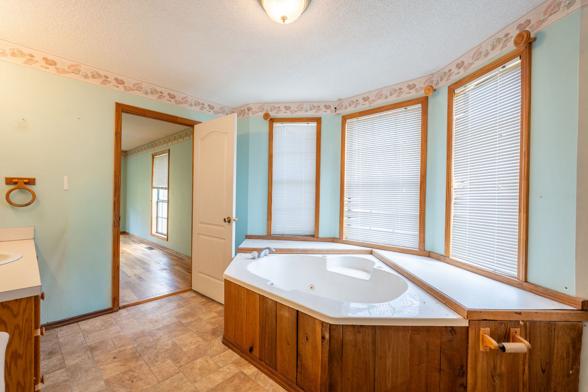 1919 Bear Creek Road Collinwood, TN 38450 - Photo 15 of 29 a bathroom with a granite countertop sink and a large mirror