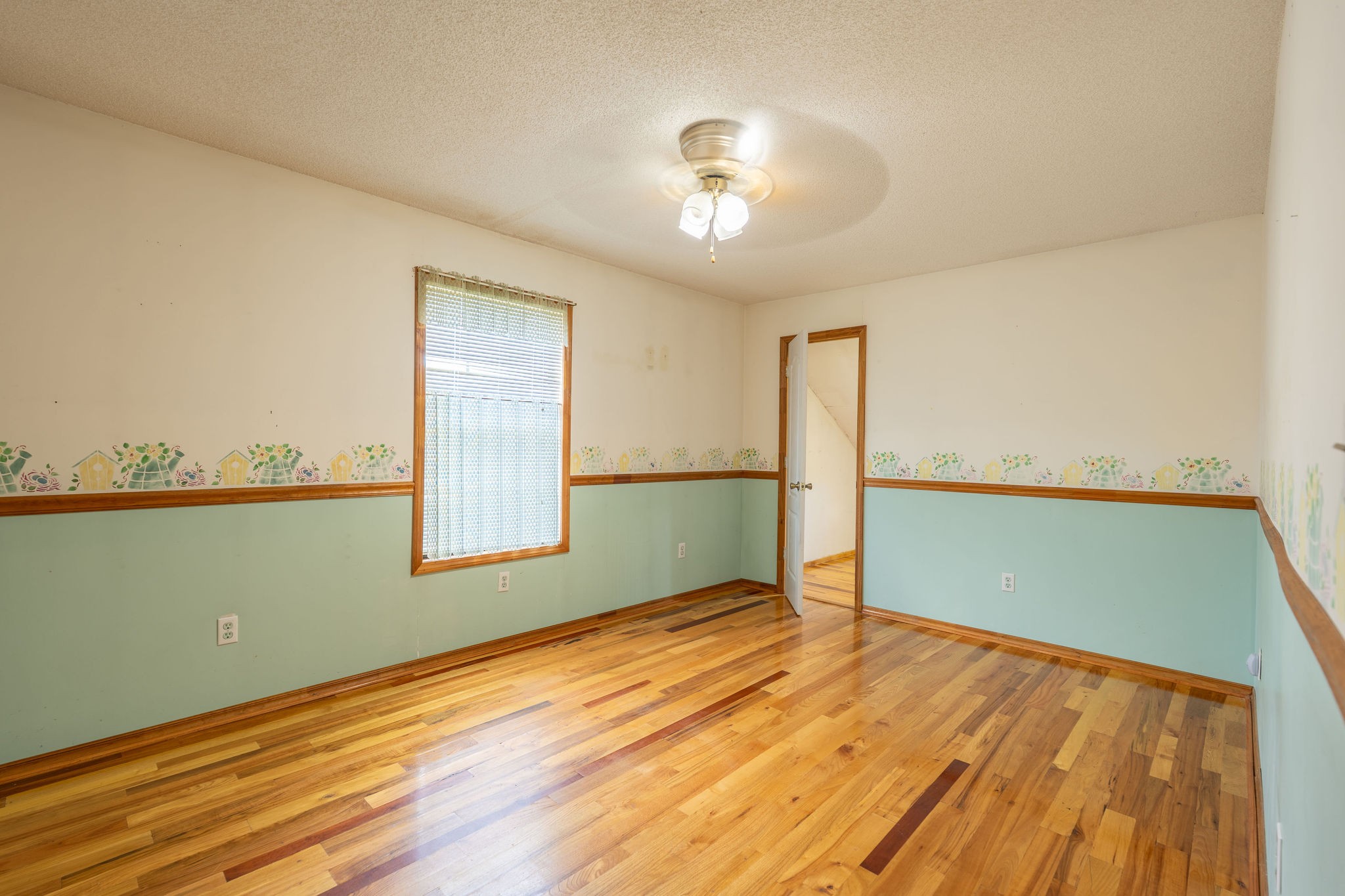 1919 Bear Creek Road Collinwood, TN 38450 - Photo 17 of 29 a view of a room with wooden floor and a ceiling fan