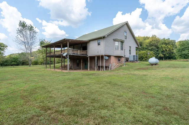 a view of a house with a backyard and garden