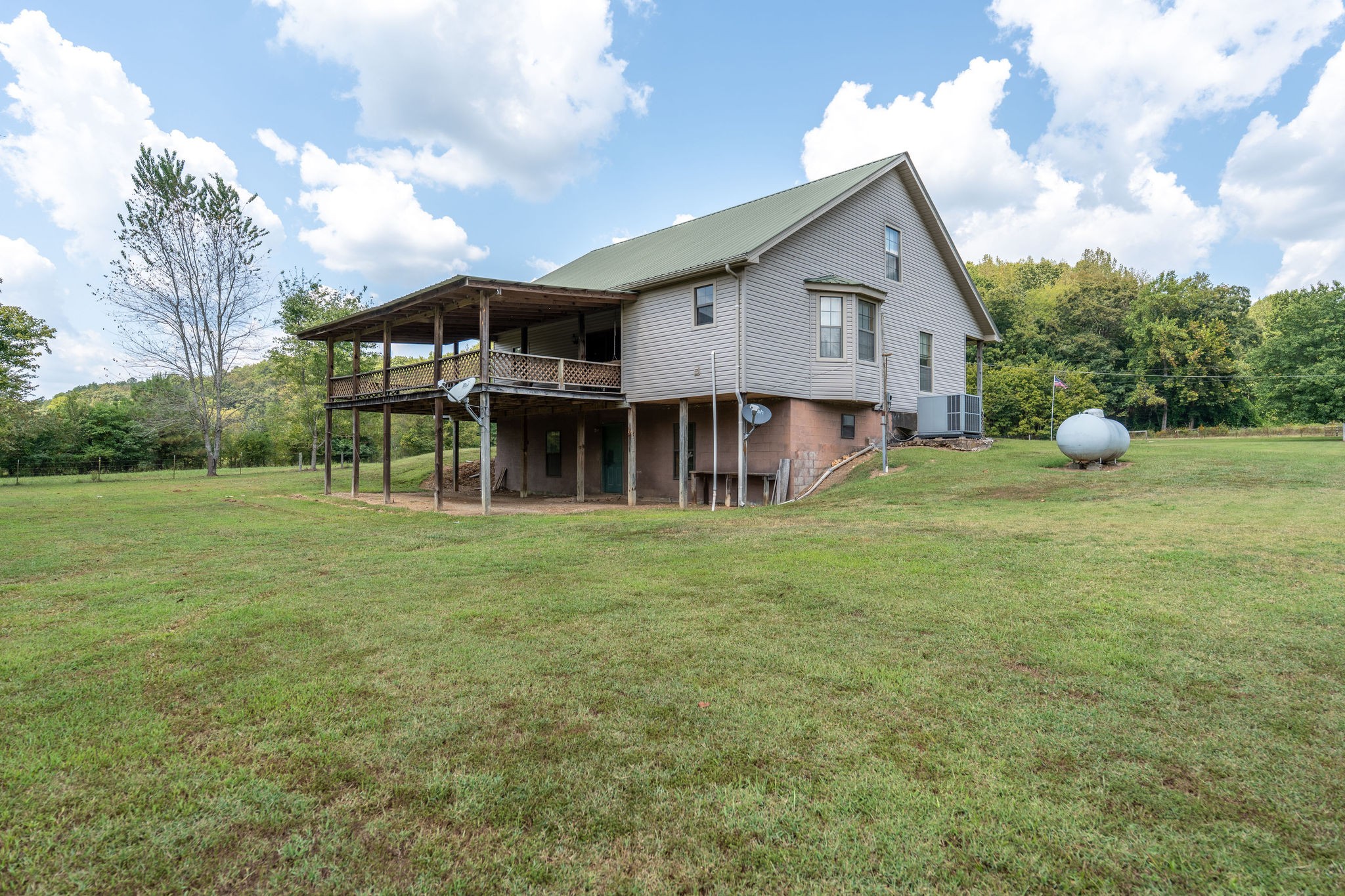 1919 Bear Creek Road Collinwood, TN 38450 - Photo 5 of 29 a view of a house with a backyard and garden