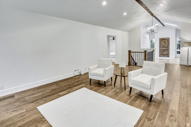 1320 Canyon Park Road Bountiful, UT 84010 - Photo 5 of 28 Sitting room with an upstairs landing, beam ceiling, light wood-style flooring, and hanging lights