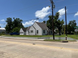 a view of a house in a big yard with large trees
