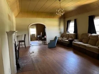 a living room with furniture and a chandelier