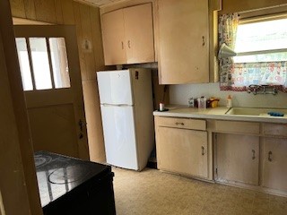 1217 East 27th Street Bryan, TX 77803 - Photo 16 of 27 a kitchen with a refrigerator sink and cabinets