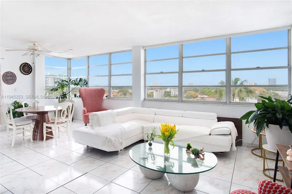 a living room with furniture and a large window