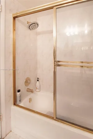 a bathroom with a shower and a glass door