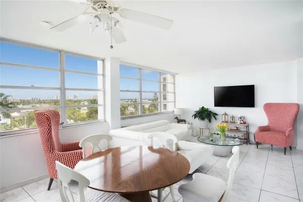 a dining room with furniture a chandelier and window