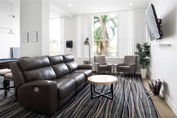 a living room with furniture and a large window