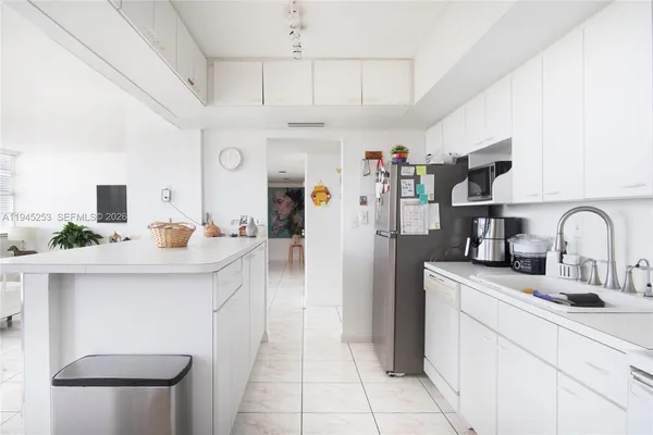a kitchen with stainless steel appliances a sink and a refrigerator