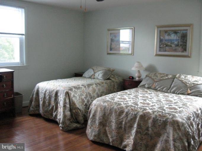 6900 Fieldcrest Road Baltimore, MD 21215 - Photo 11 of 15 a bedroom with two beds and a window